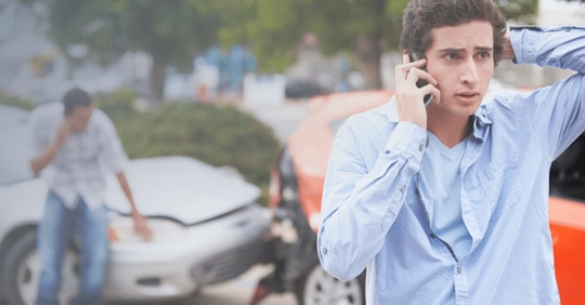 man on the phone with insurance after a crash