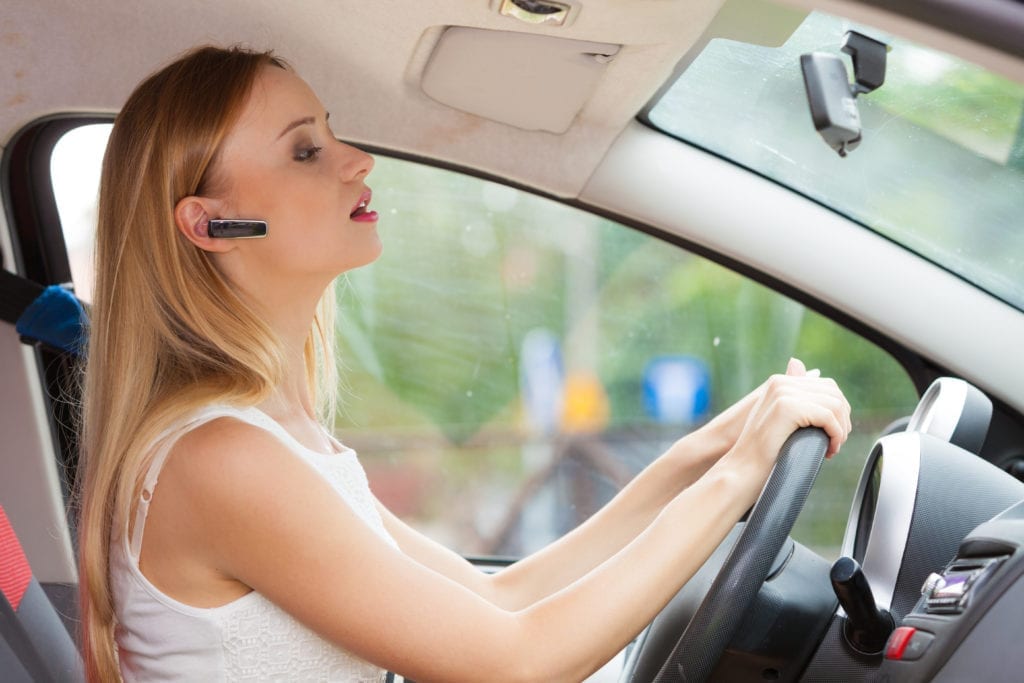 Lady Driving with a Bluetooth Headset